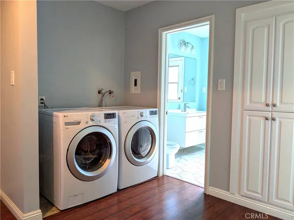 a utility room with wooden floor