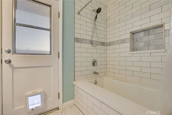 a bathroom with a bathtub and shower