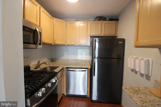 a kitchen with a sink and a refrigerator