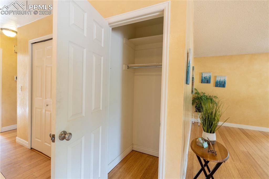 961 Columbine Avenue Colorado Springs, CO 80904 - Photo 11 of 24 a view of a hallway with wooden floor and a bathroom