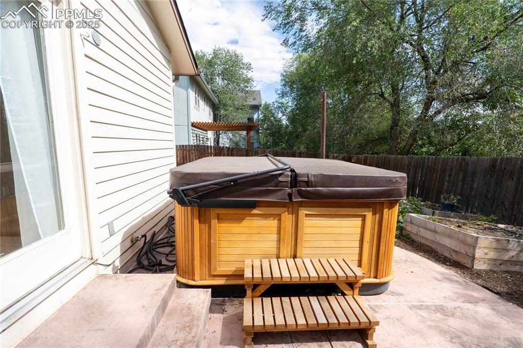 961 Columbine Avenue Colorado Springs, CO 80904 - Photo 15 of 24 a view of a patio with a table and chairs and wooden fence