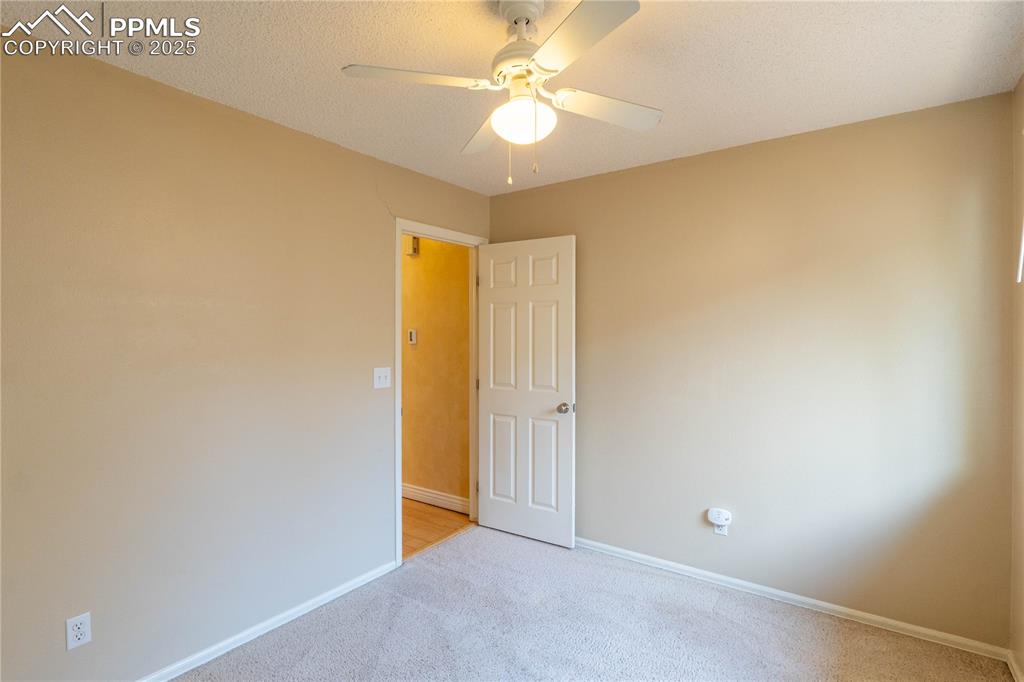 961 Columbine Avenue Colorado Springs, CO 80904 - Photo 23 of 24 an empty room with a ceiling fan and a window