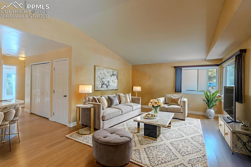961 Columbine Avenue Colorado Springs, CO 80904 - Photo 4 of 24 a living room with furniture a flat screen tv and a rug