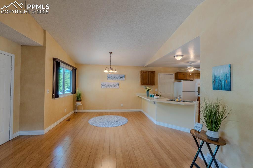 961 Columbine Avenue Colorado Springs, CO 80904 - Photo 7 of 24 a kitchen with stainless steel appliances a dining table chairs and wooden floor