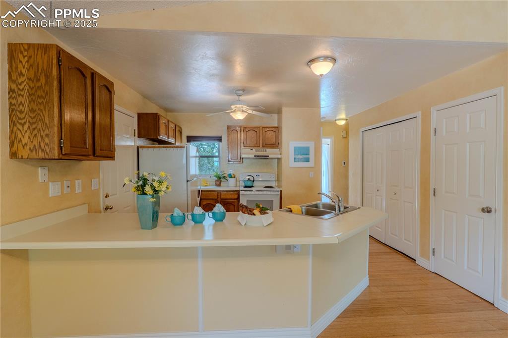961 Columbine Avenue Colorado Springs, CO 80904 - Photo 8 of 24 a kitchen with a sink a counter top space and cabinets