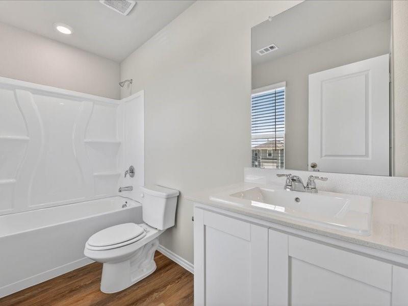 5568 Corduroy Road Krum, TX 76249 - Photo 14 of 23 a bathroom with a sink a toilet and shower