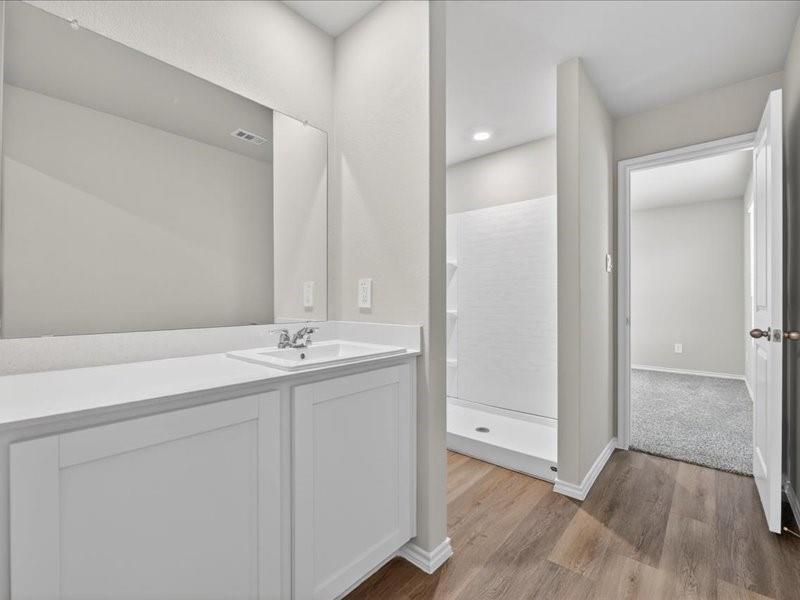 5568 Corduroy Road Krum, TX 76249 - Photo 17 of 23 a bathroom with a granite countertop sink and a mirror