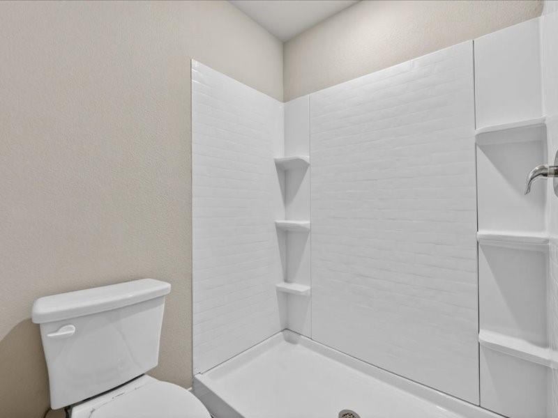 5568 Corduroy Road Krum, TX 76249 - Photo 18 of 23 a white toilet sitting next to a shower