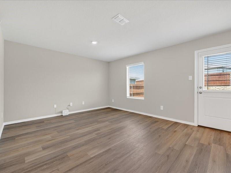 5568 Corduroy Road Krum, TX 76249 - Photo 3 of 23 an empty room with wooden floor and windows