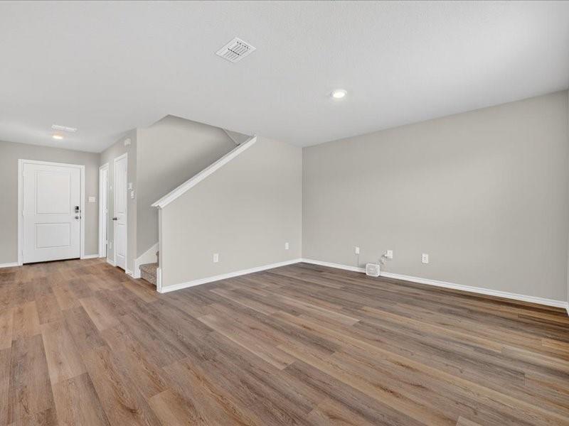5568 Corduroy Road Krum, TX 76249 - Photo 4 of 23 a view of an empty room with wooden floor and a window