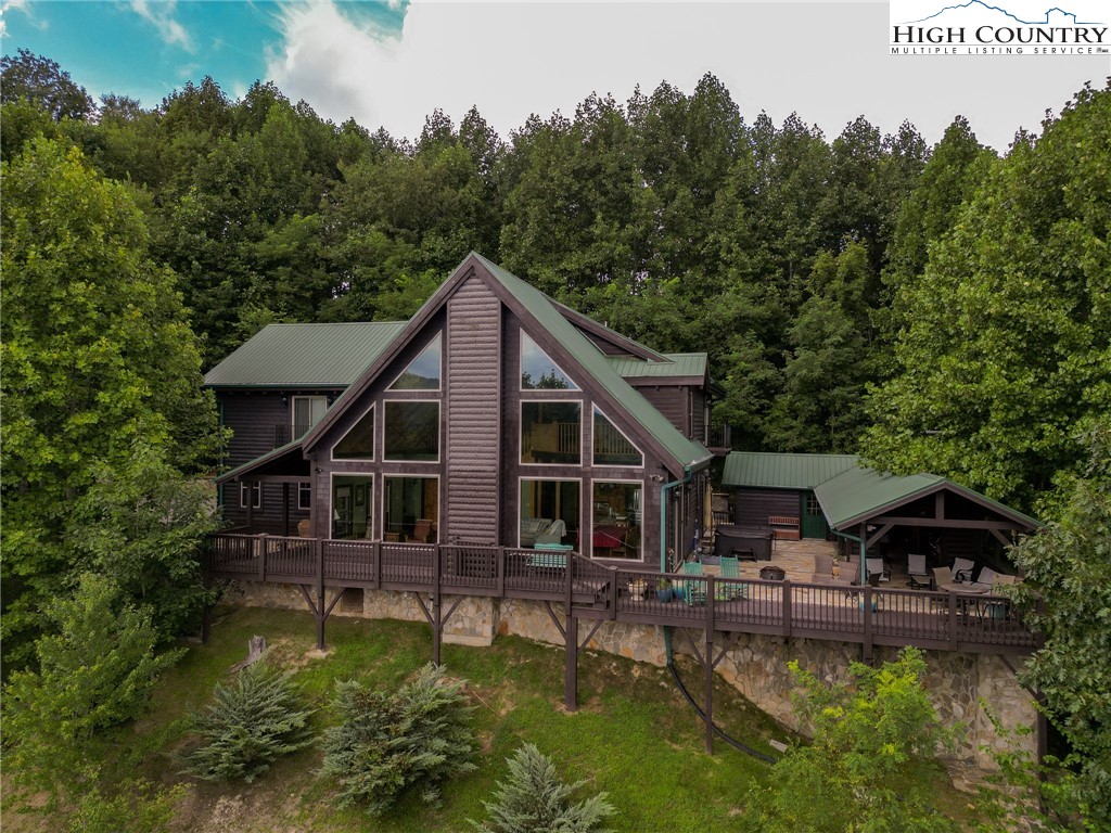 a aerial view of a house with swimming pool next to a yard
