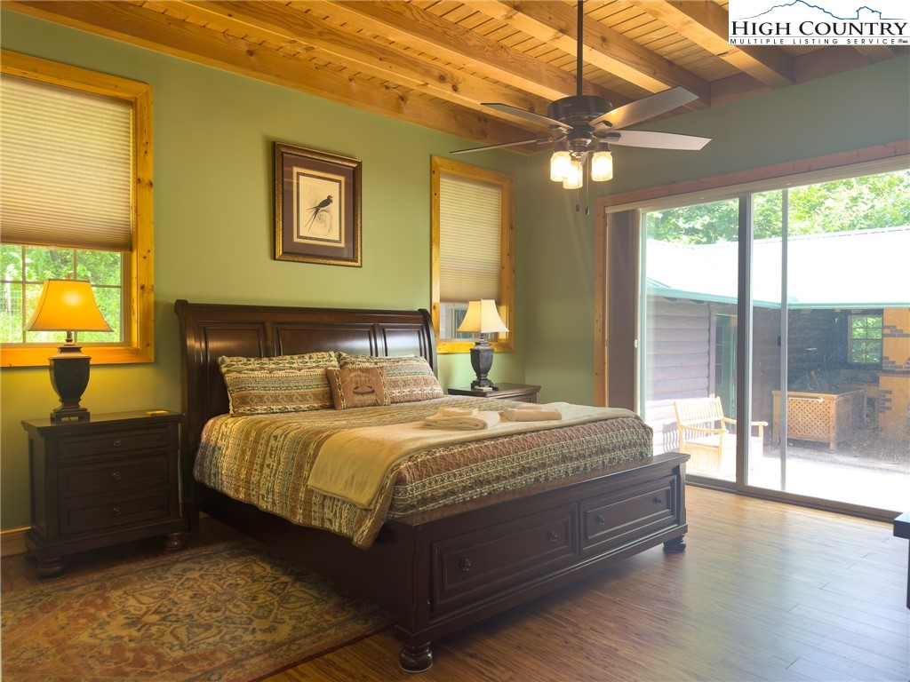 150 Tuscany Ridge Sugar Grove, NC 28679 - Photo 14 of 45 a bedroom with a bed lamps and a large window