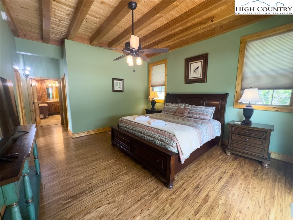 150 Tuscany Ridge Sugar Grove, NC 28679 - Photo 15 of 45 a bedroom with a bed lamps and wooden floor