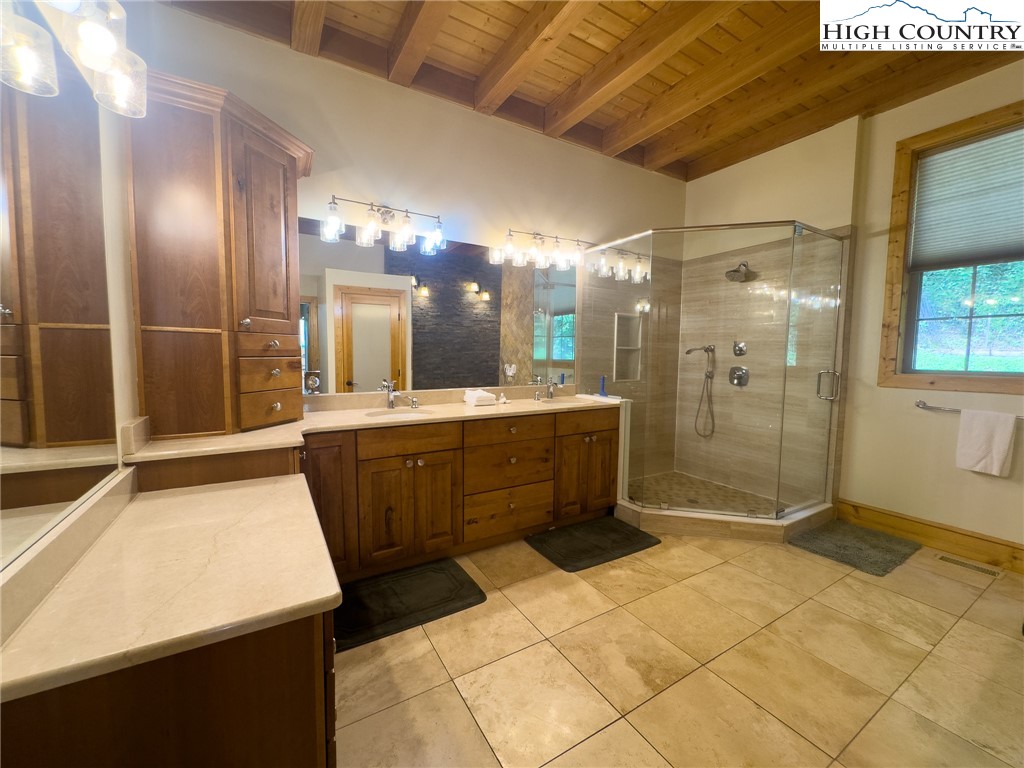 150 Tuscany Ridge Sugar Grove, NC 28679 - Photo 17 of 45 a bathroom with a mirror a sink and a shower