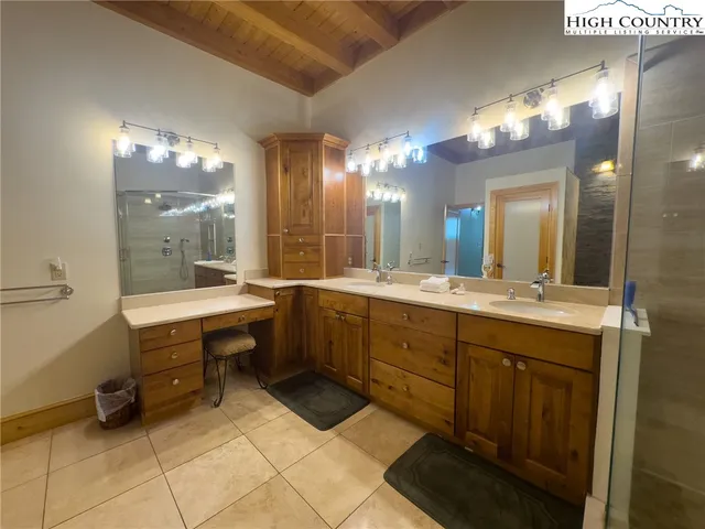 a spacious bathroom with a double vanity sink and a mirror