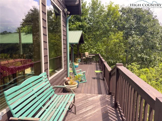a view of a patio with table and chairs potted plants with wooden fence