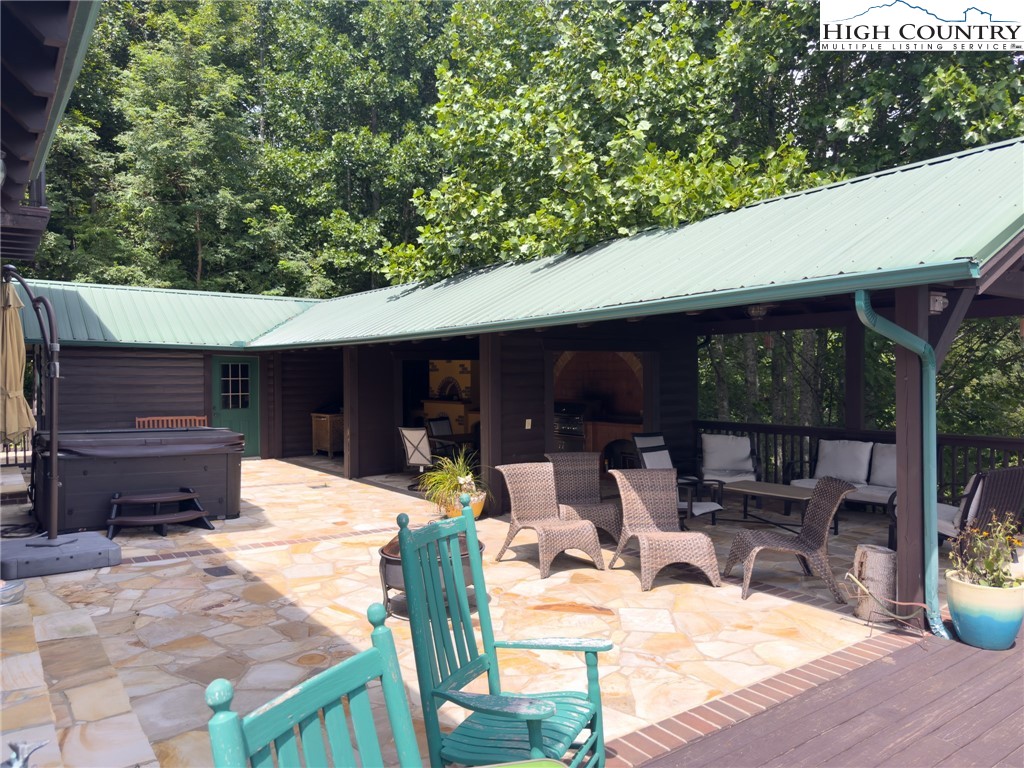150 Tuscany Ridge Sugar Grove, NC 28679 - Photo 39 of 45 a view of a patio with table and chairs potted plants with wooden fence