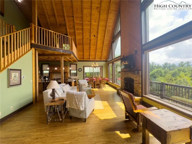 a view of a patio with table and chairs floor to ceiling window with yard