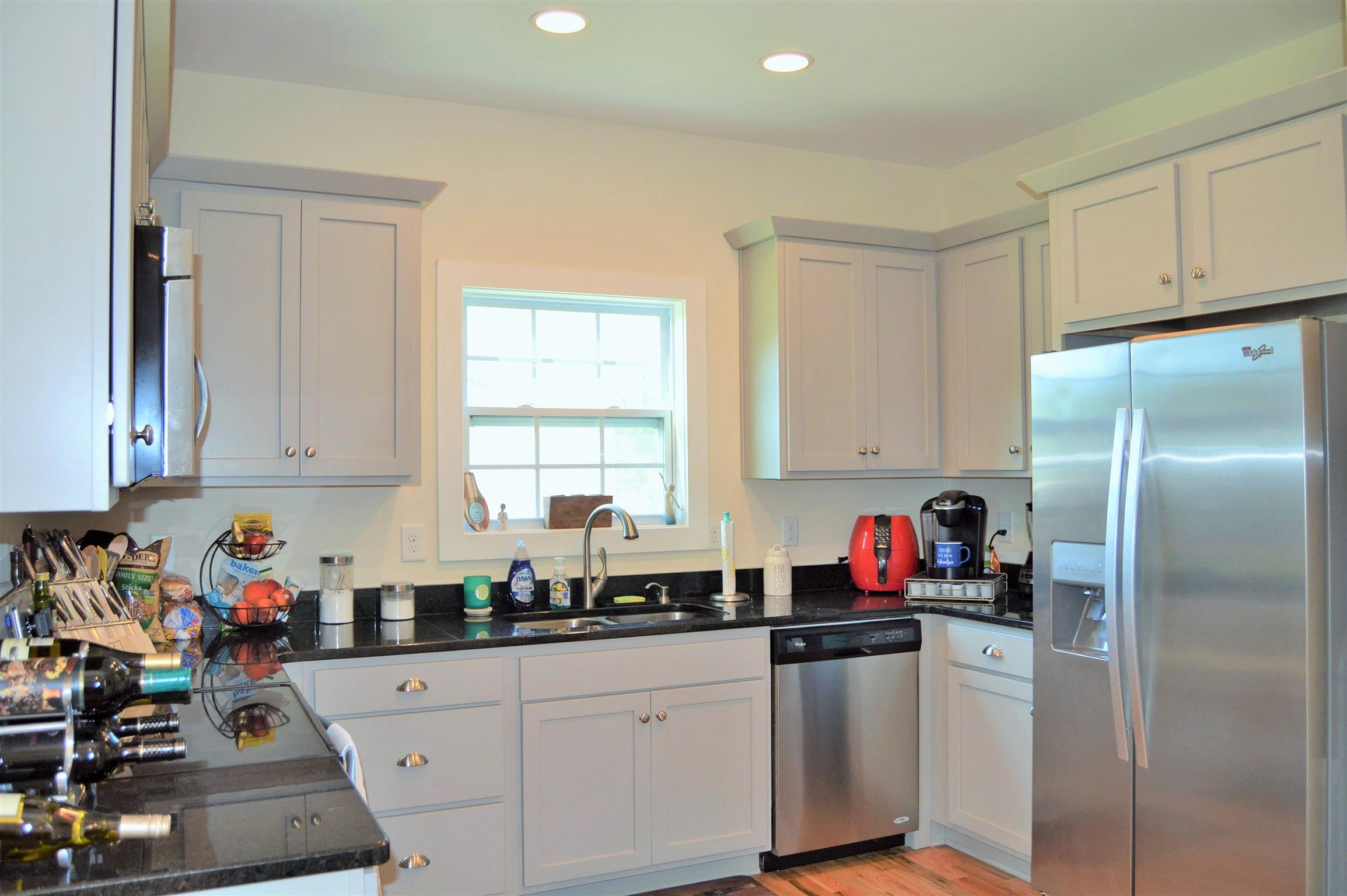 870 Tidwell Road Burns, TN 37029 - Photo 8 of 28 a kitchen with granite countertop a refrigerator sink and cabinets
