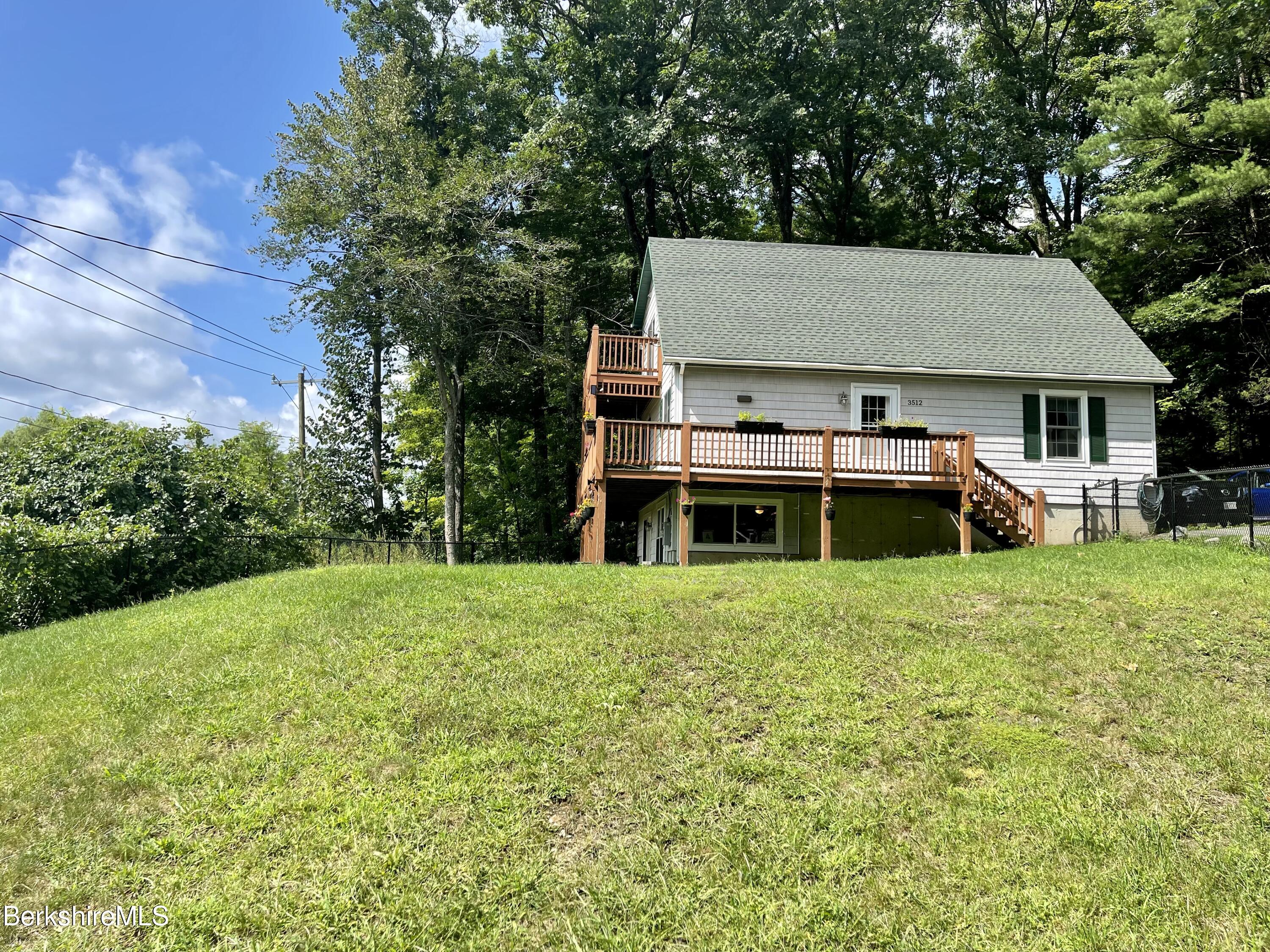 3512 Jacobs Ladder Road Becket, MA 01223 - Photo 2 of 42 a view of a house with backyard and garden