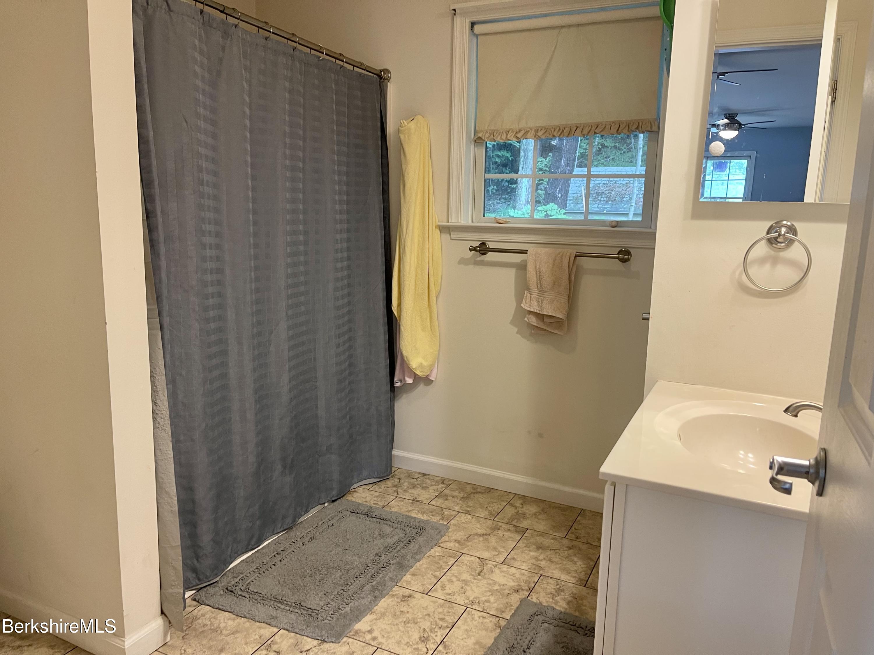 3512 Jacobs Ladder Road Becket, MA 01223 - Photo 16 of 42 a bathroom with a granite countertop shower and a sink