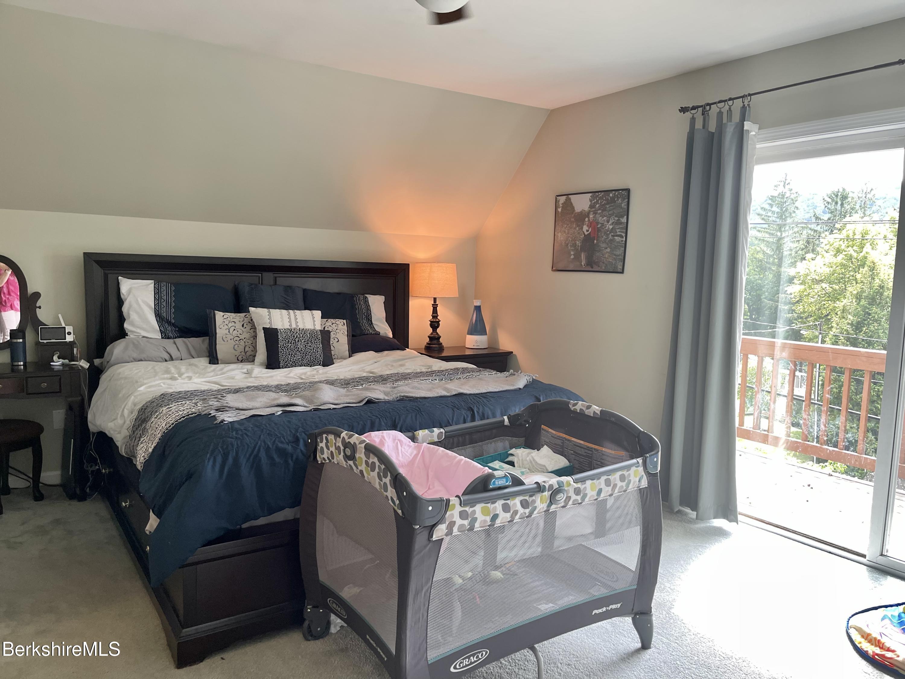 3512 Jacobs Ladder Road Becket, MA 01223 - Photo 19 of 42 a bed sitting in a bedroom next to a window