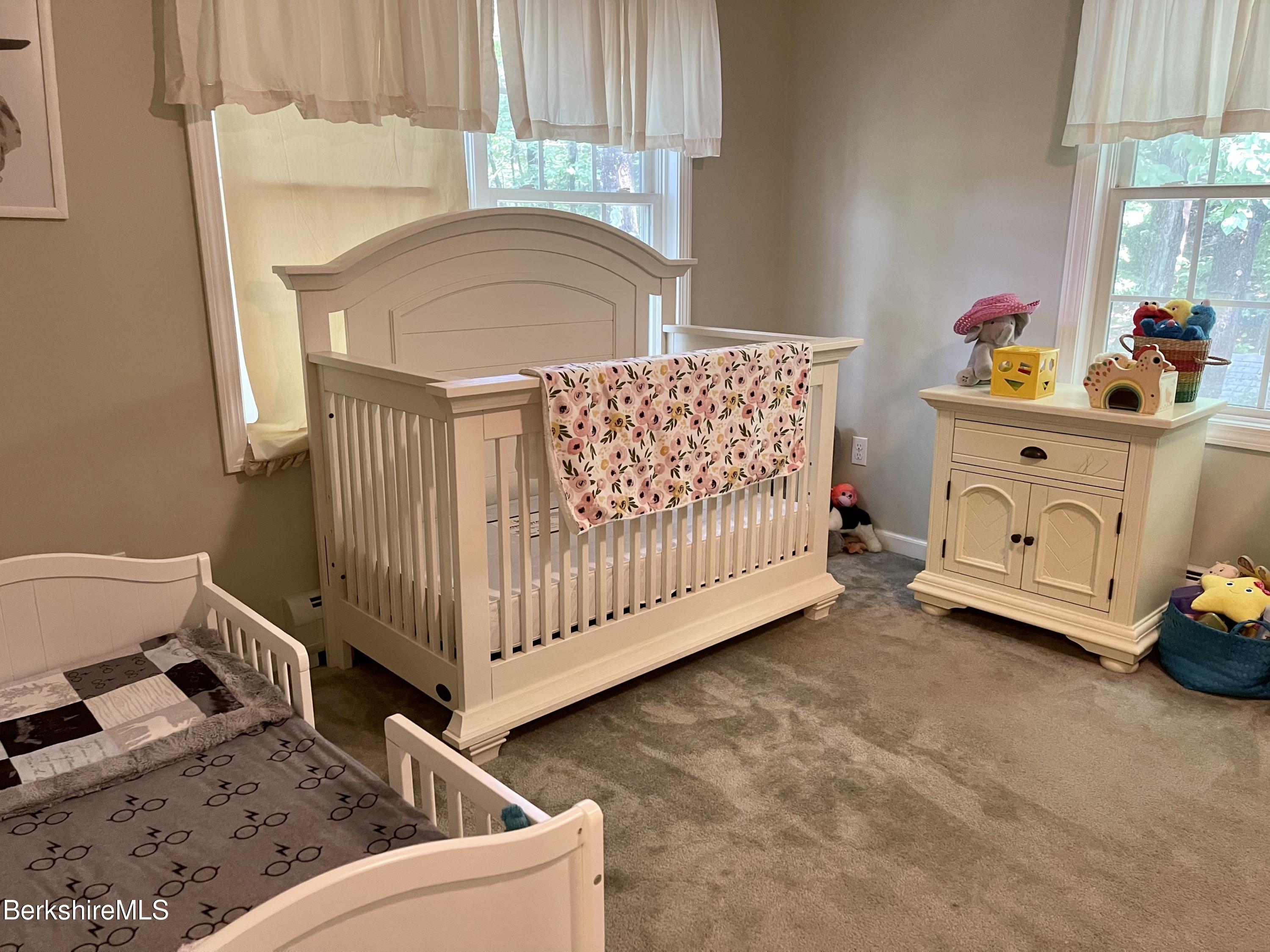 3512 Jacobs Ladder Road Becket, MA 01223 - Photo 27 of 42 a living room with a baby crib furniture a chandelier and a baby crib