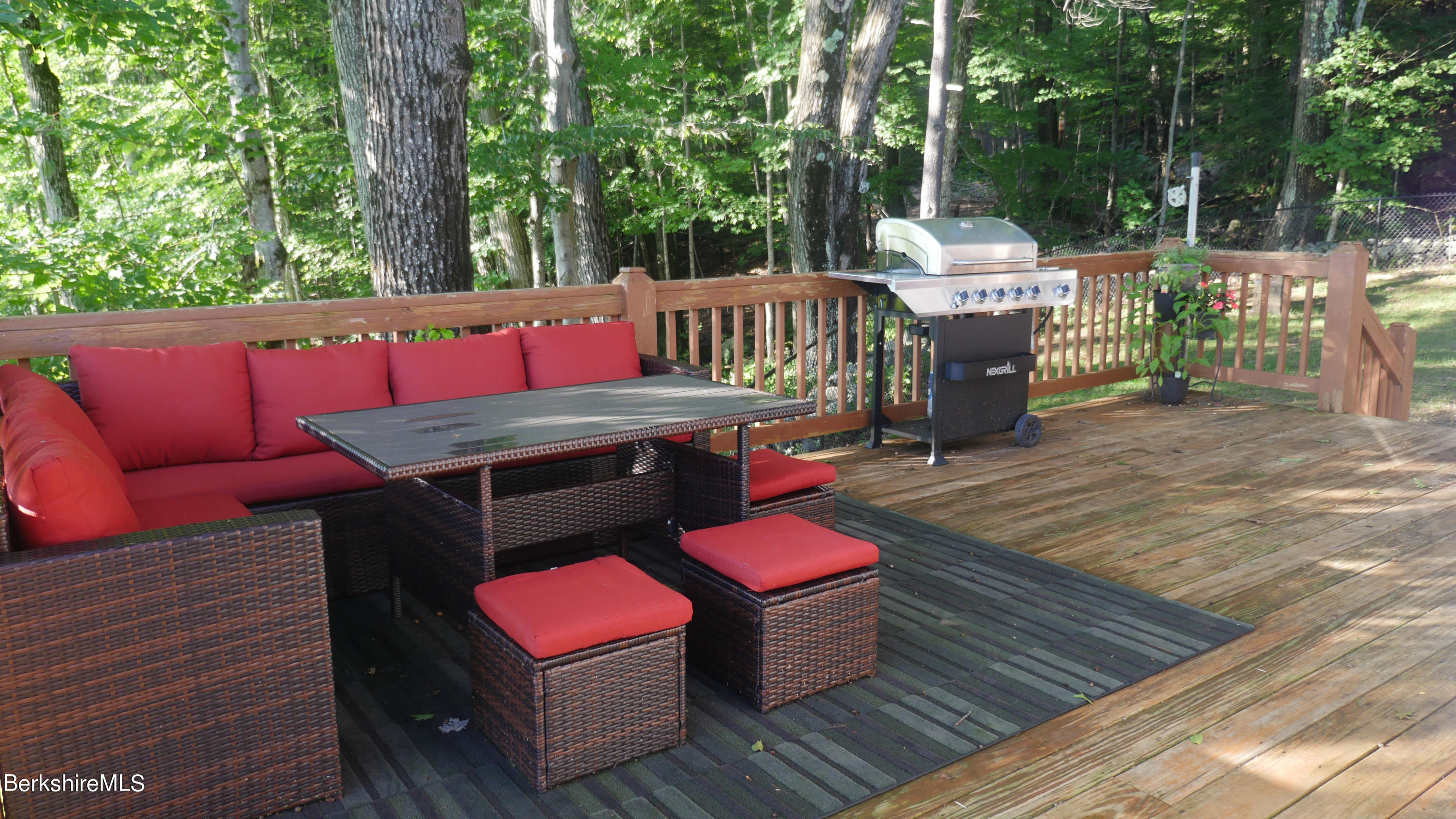 3512 Jacobs Ladder Road Becket, MA 01223 - Photo 34 of 42 a view of a deck with couches table and chairs with wooden floor
