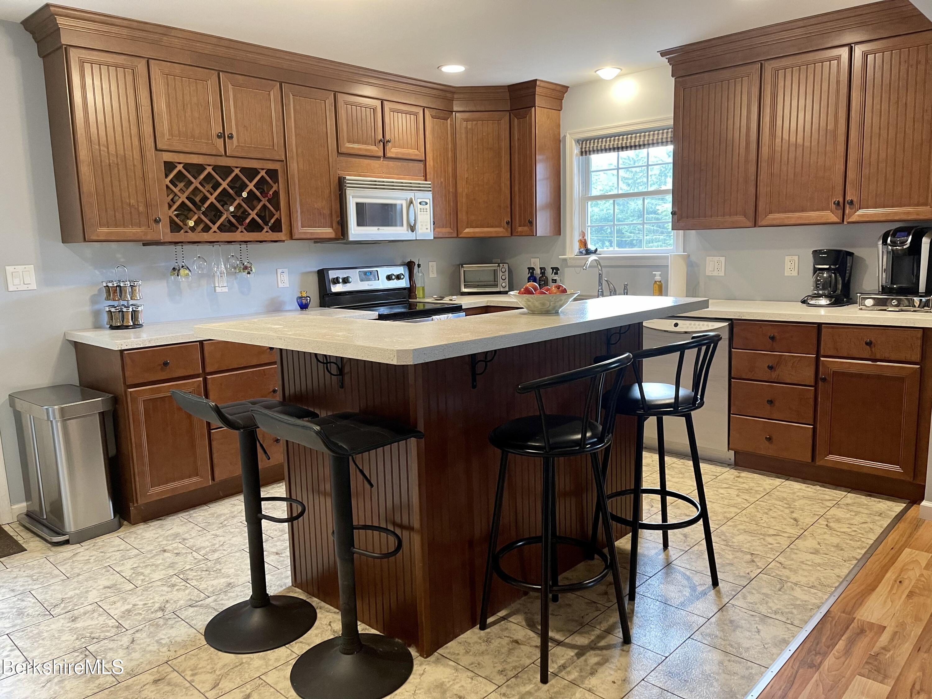 3512 Jacobs Ladder Road Becket, MA 01223 - Photo 8 of 42 a kitchen with stainless steel appliances granite countertop a table chairs sink and cabinets