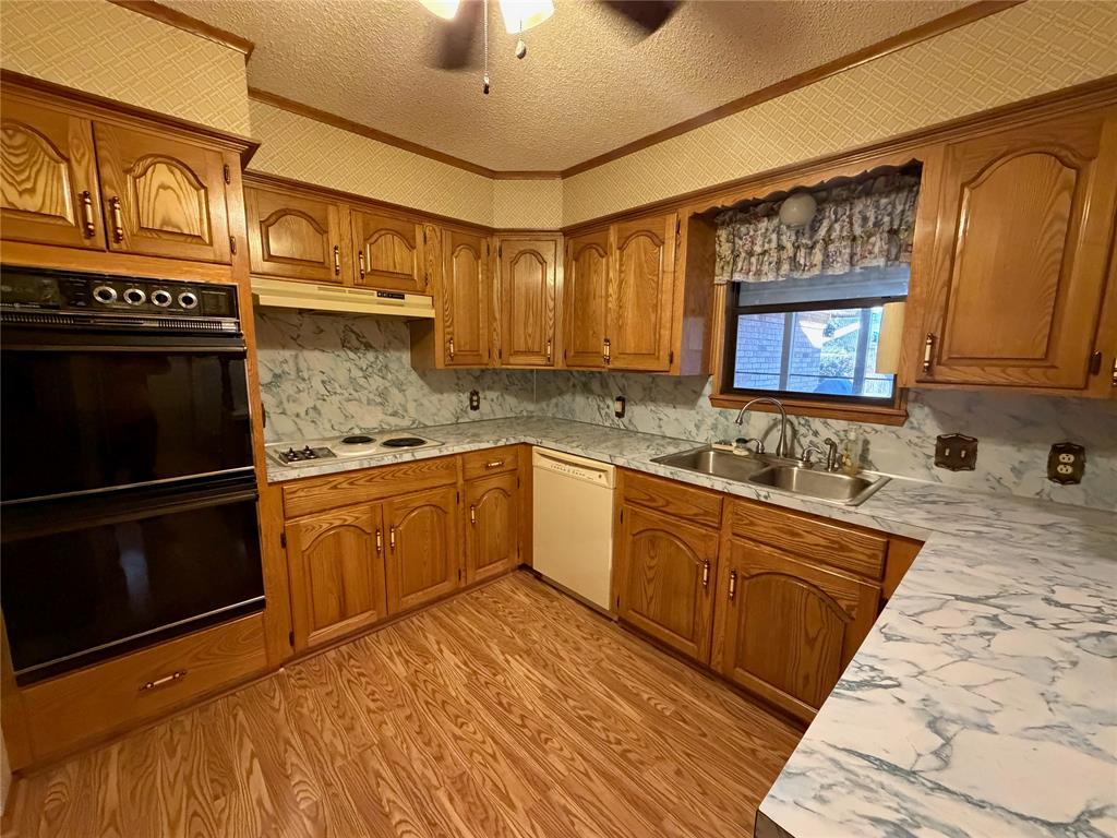 1218 Nottingham Road Abilene, TX 79602 - Photo 11 of 22 a kitchen with a sink stove and cabinets