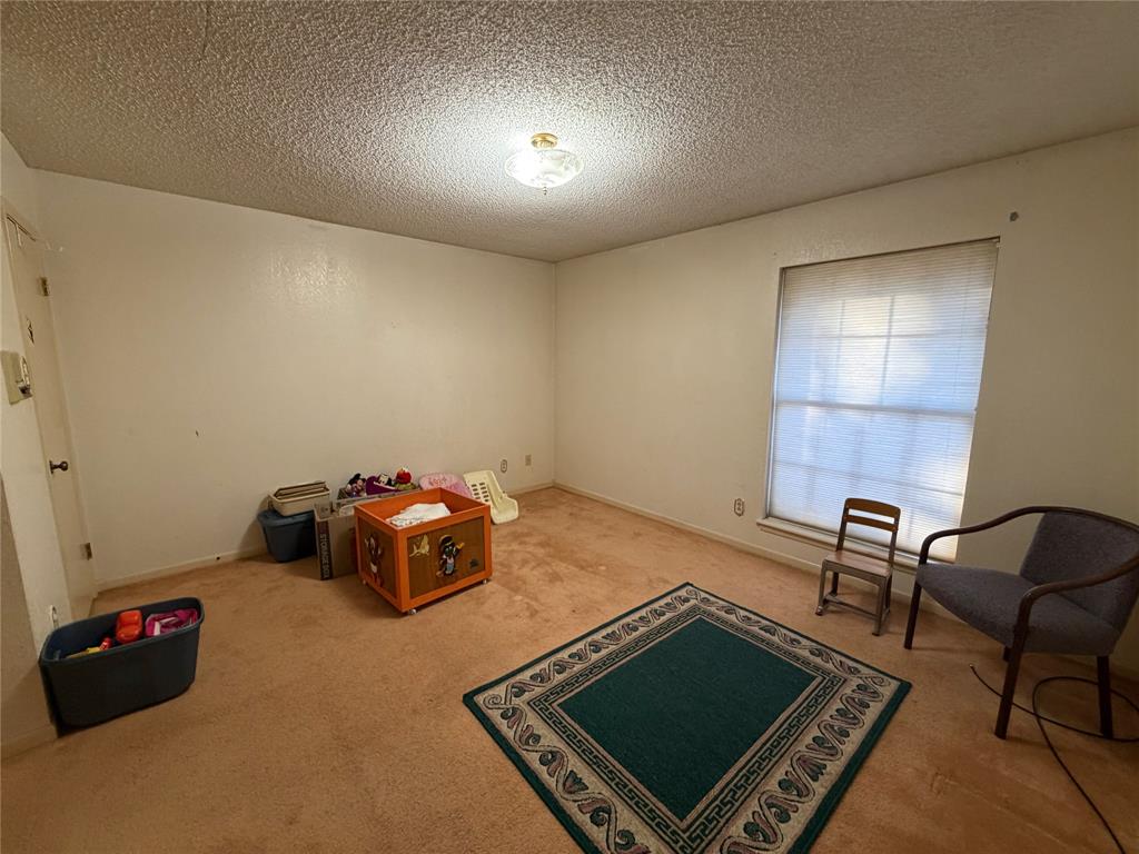 1218 Nottingham Road Abilene, TX 79602 - Photo 12 of 22 a room with gym equipment and a rug