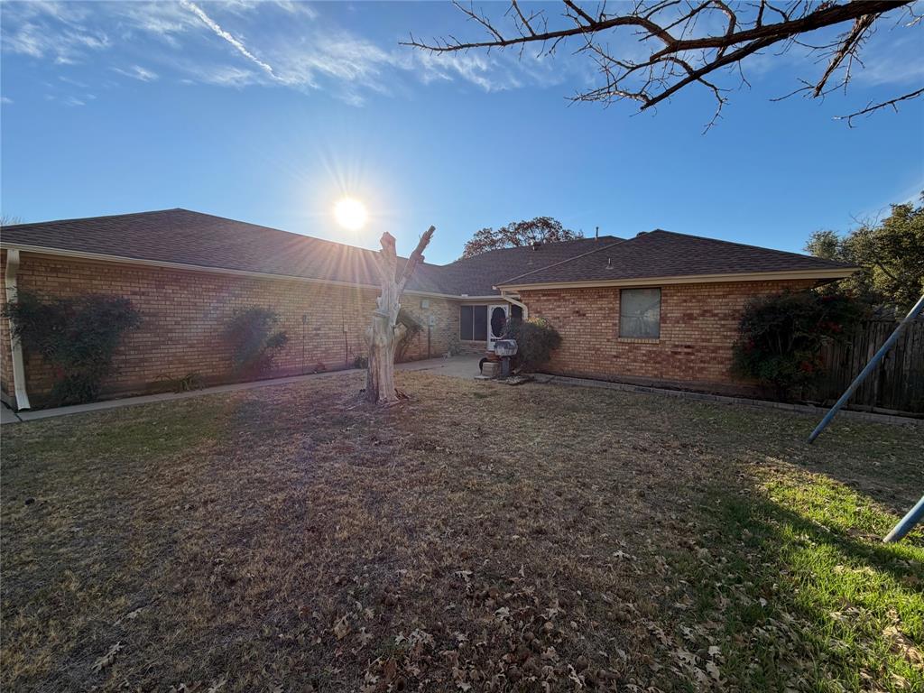 1218 Nottingham Road Abilene, TX 79602 - Photo 22 of 22 a view of a dry yard with wooden fence