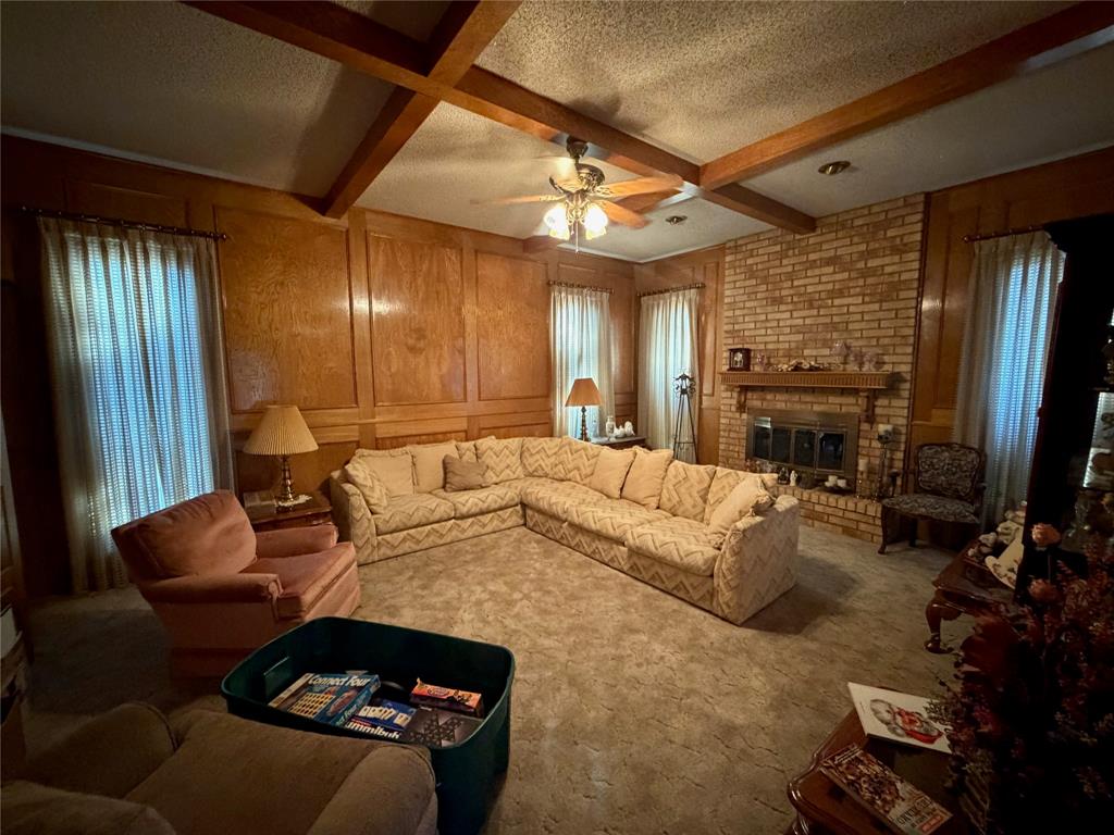 1218 Nottingham Road Abilene, TX 79602 - Photo 4 of 22 a living room with furniture a flat screen tv and a fireplace