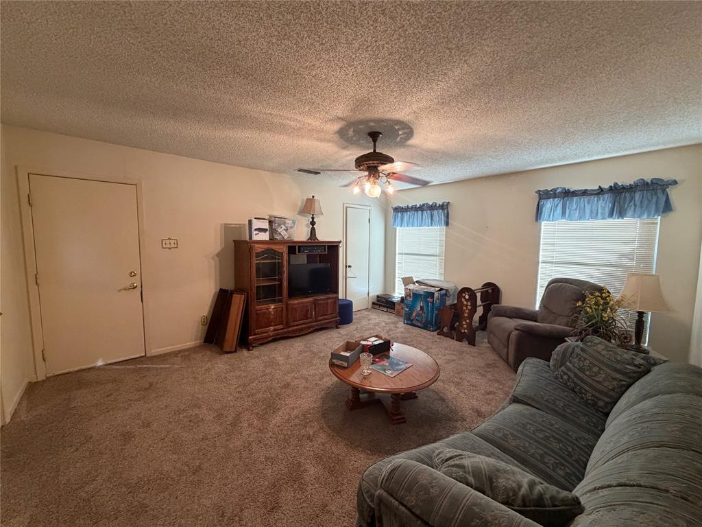1218 Nottingham Road Abilene, TX 79602 - Photo 8 of 22 a living room with furniture and a chandelier