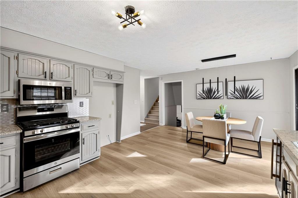 752 Maple Drive Riverdale, GA 30274 - Photo 12 of 35 a kitchen with a stove and a microwave