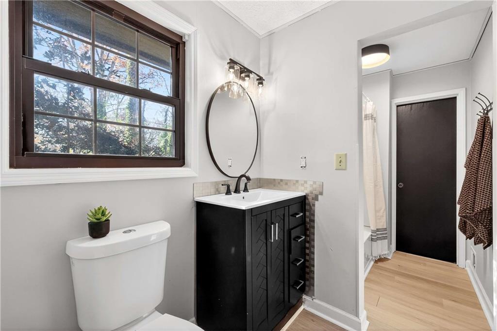 752 Maple Drive Riverdale, GA 30274 - Photo 13 of 35 a bathroom with a toilet a sink and a mirror