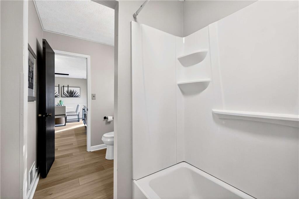 752 Maple Drive Riverdale, GA 30274 - Photo 14 of 35 a bathroom with a shower and toilet