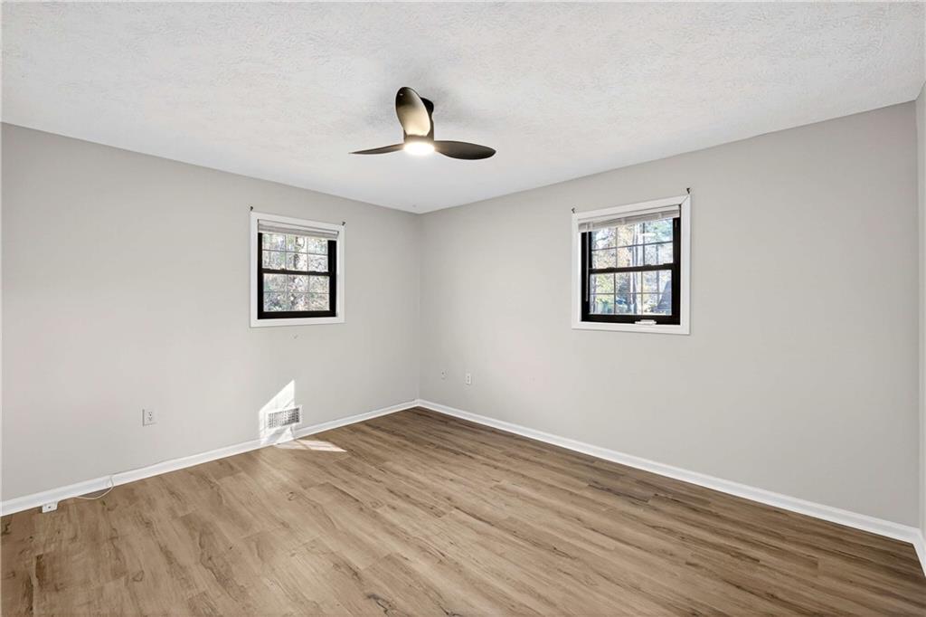 752 Maple Drive Riverdale, GA 30274 - Photo 18 of 35 a view of an empty room with wooden floor and a window