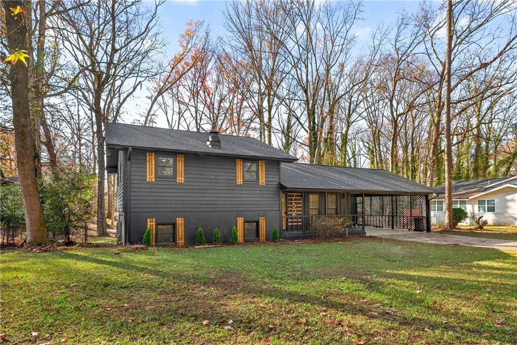 752 Maple Drive Riverdale, GA 30274 - Photo 2 of 35 a view of a yard in front of a brick house with large windows