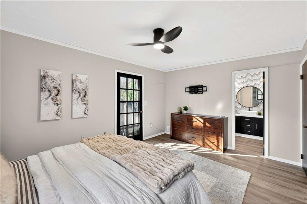 752 Maple Drive Riverdale, GA 30274 - Photo 22 of 35 a bedroom with a bed and wooden floor