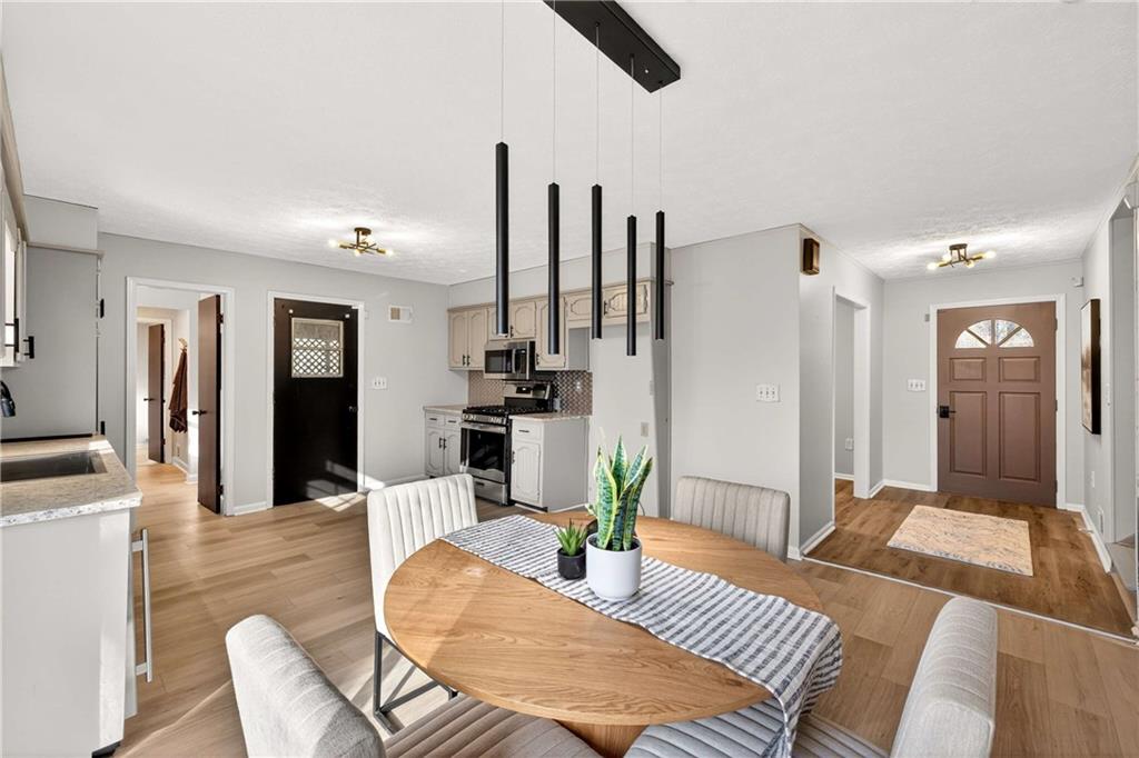 752 Maple Drive Riverdale, GA 30274 - Photo 8 of 35 a living room with furniture kitchen view and a wooden floor