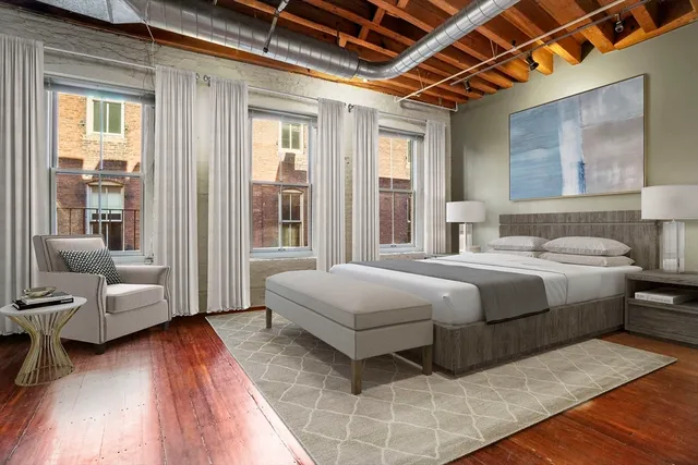 a bedroom with a large bed and a couch