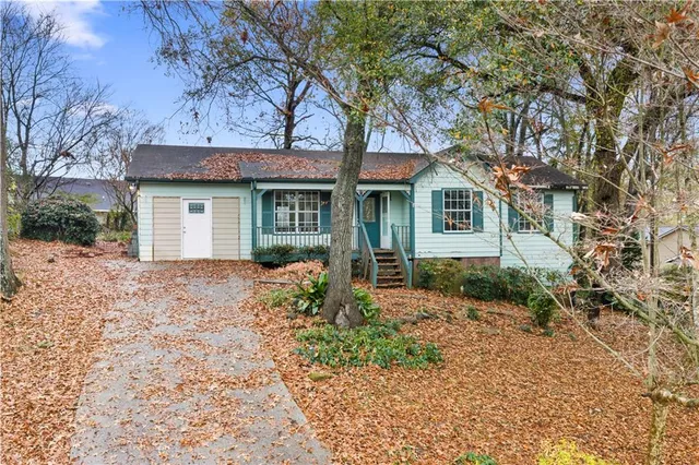 a front view of a house with a garden