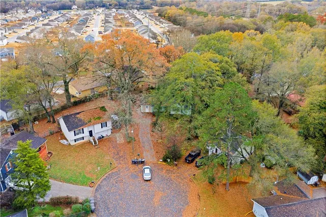 an aerial view of residential house with yard and swimming pool