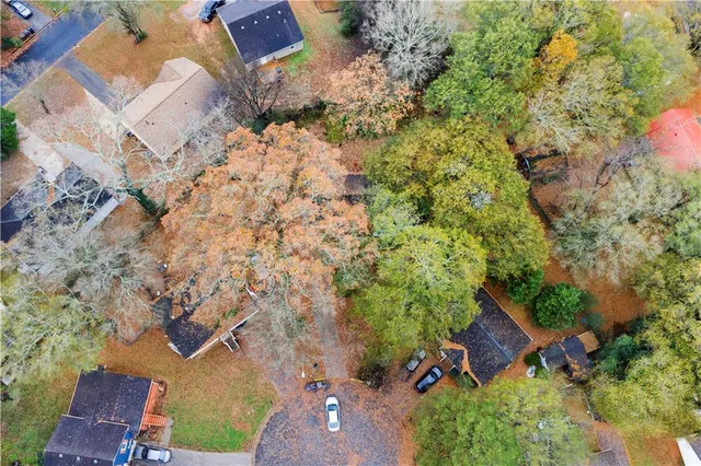 an aerial view of a house with yard and outdoor seating