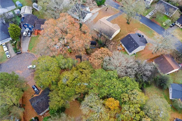 an aerial view of a house with a yard