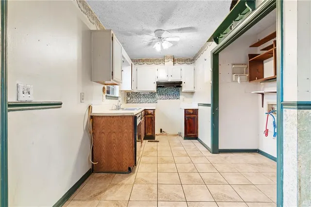 a kitchen with stainless steel appliances granite countertop a refrigerator a stove and a sink