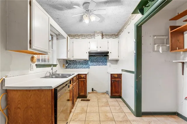 a kitchen with stainless steel appliances granite countertop a sink and dishwasher a refrigerator with wooden cabinets