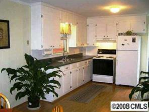 2187 Airdale Road Lancaster, SC 29720 - Photo 3 of 8 a kitchen with stainless steel appliances a white sink cabinets and a potted plant