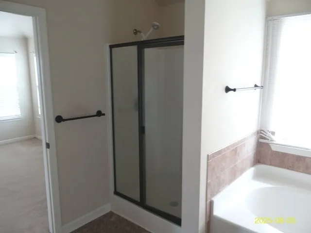 a bathroom with a tub and shower